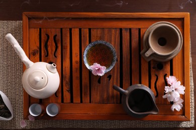 Beautiful set for traditional tea ceremony on wooden table, flat lay