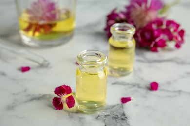 Composition with essential oils and flowers on table