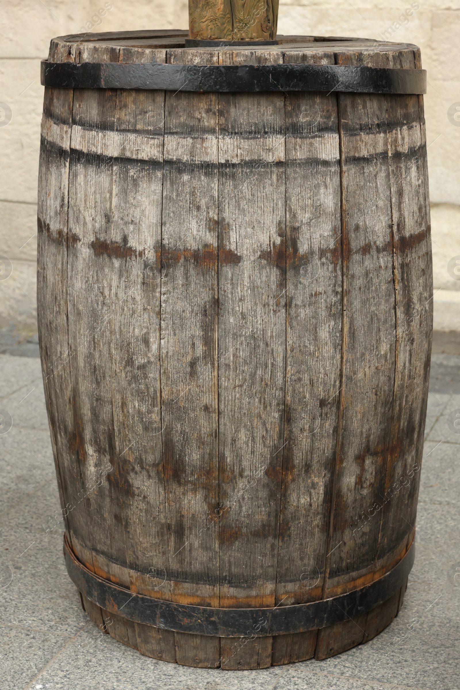 Photo of Traditional wooden barrel on street outdoors. Wine making