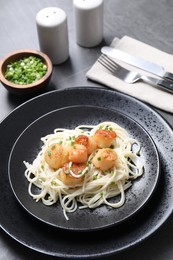 Delicious scallop pasta with green onion served on grey table