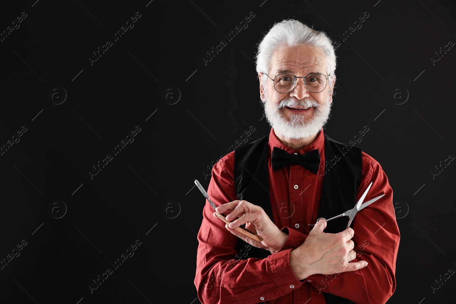 Photo of Senior man with mustache holding blade and scissors on black background, space for text