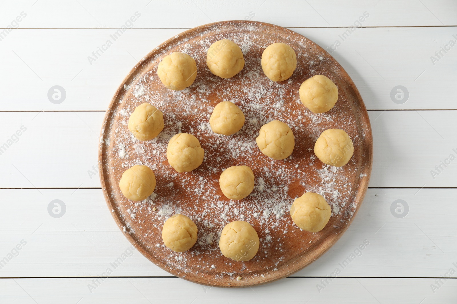 Photo of Shortcrust pastry. Raw dough balls on white wooden table, top view