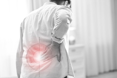 Image of Man suffering from back pain at home, closeup. Bad posture problem