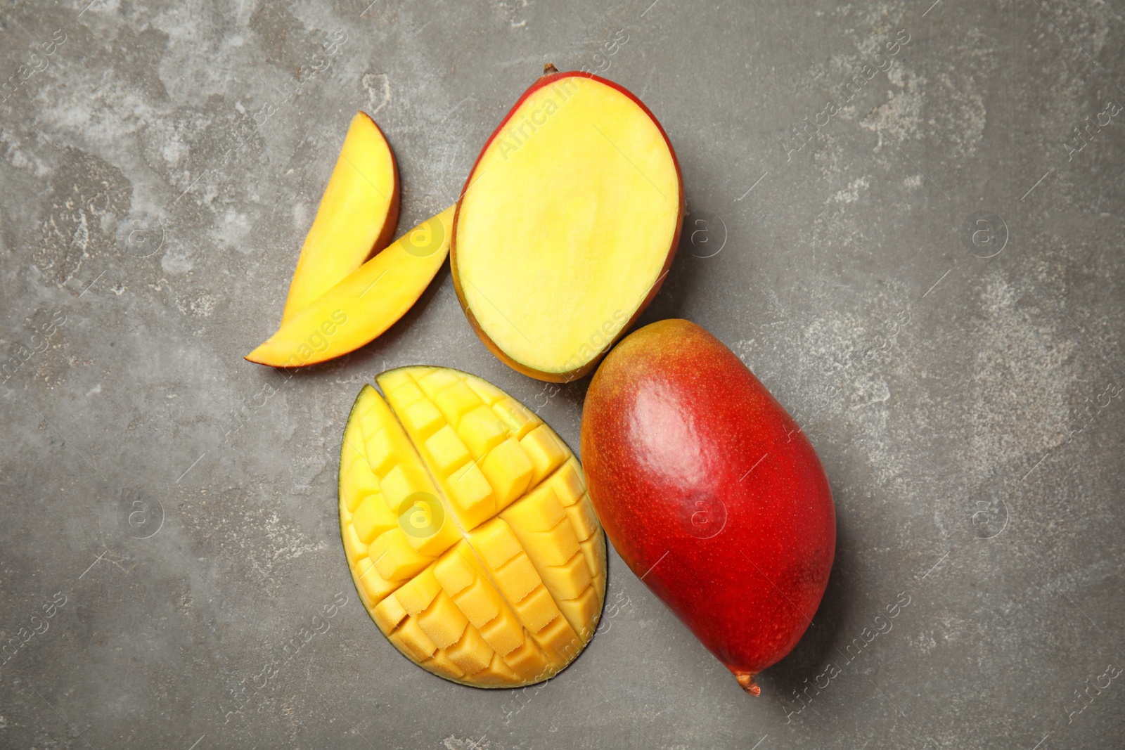 Photo of Flat lay composition with ripe mangoes on grey background