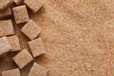 Photo of Different types of brown sugar as background, top view