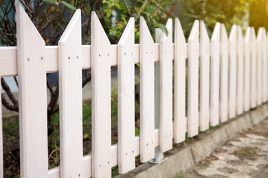 Photo of Closeup view of small wooden fence outdoors, space for text