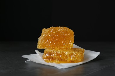 Natural honeycombs on dark table against black background