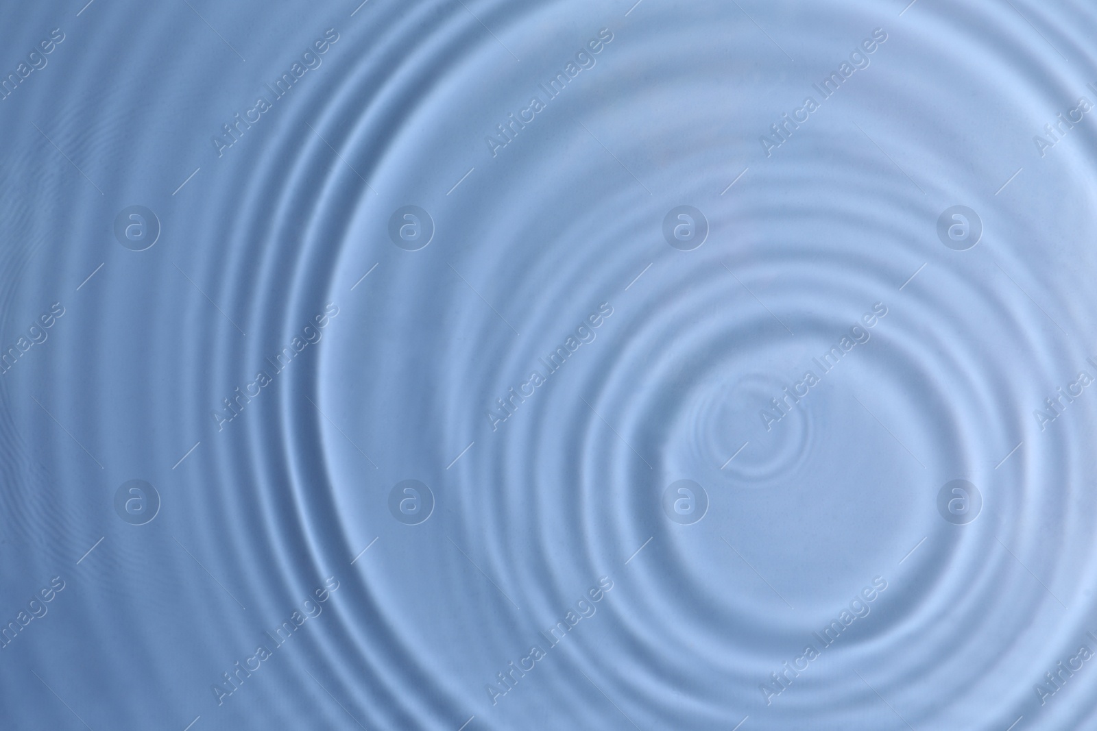 Photo of Closeup view of water with circles on blue background