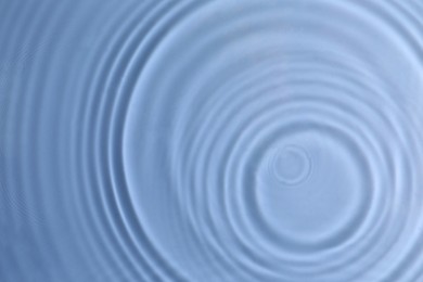 Photo of Closeup view of water with circles on blue background