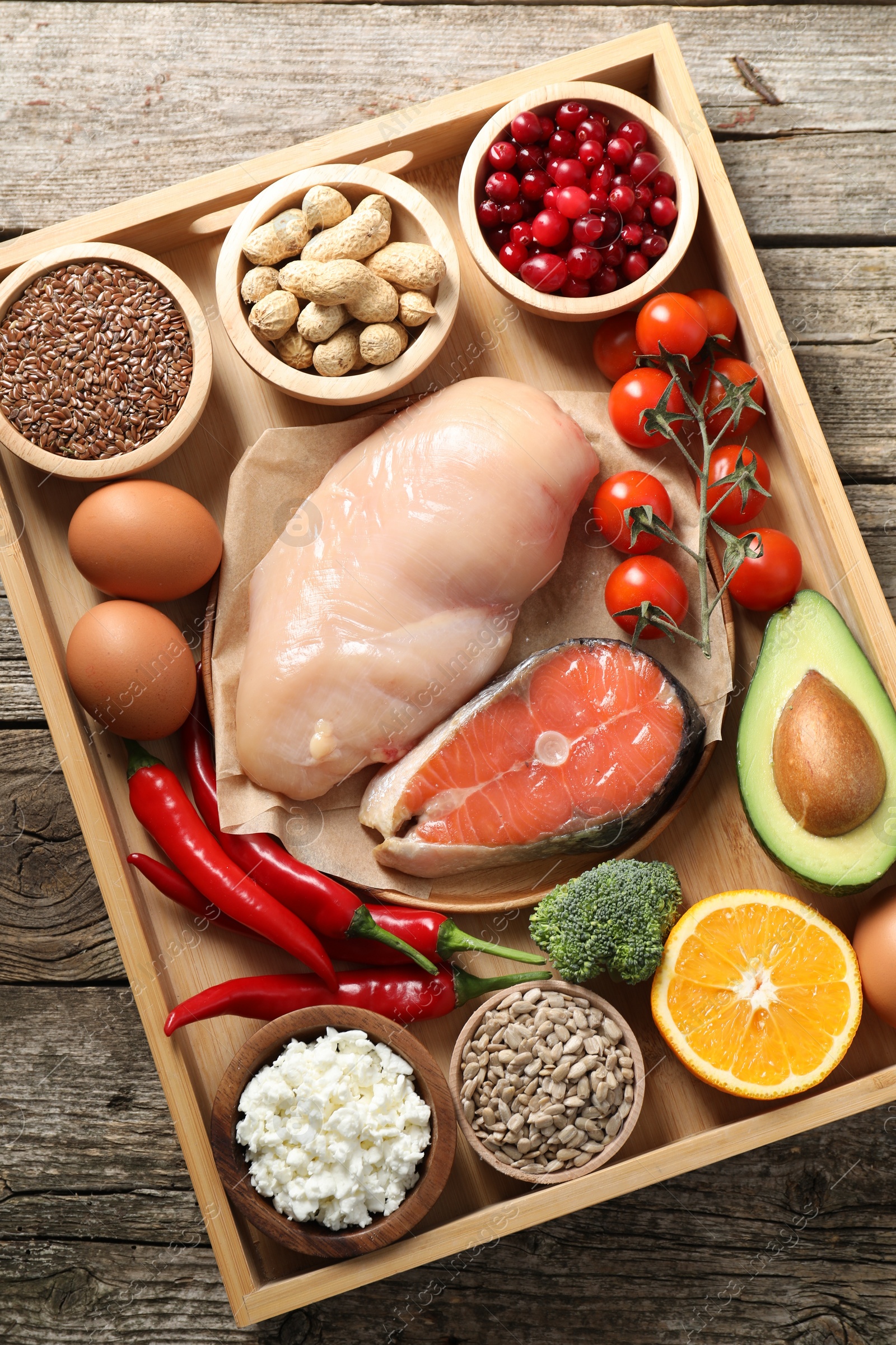 Photo of Tray with many different healthy food on wooden table, top view