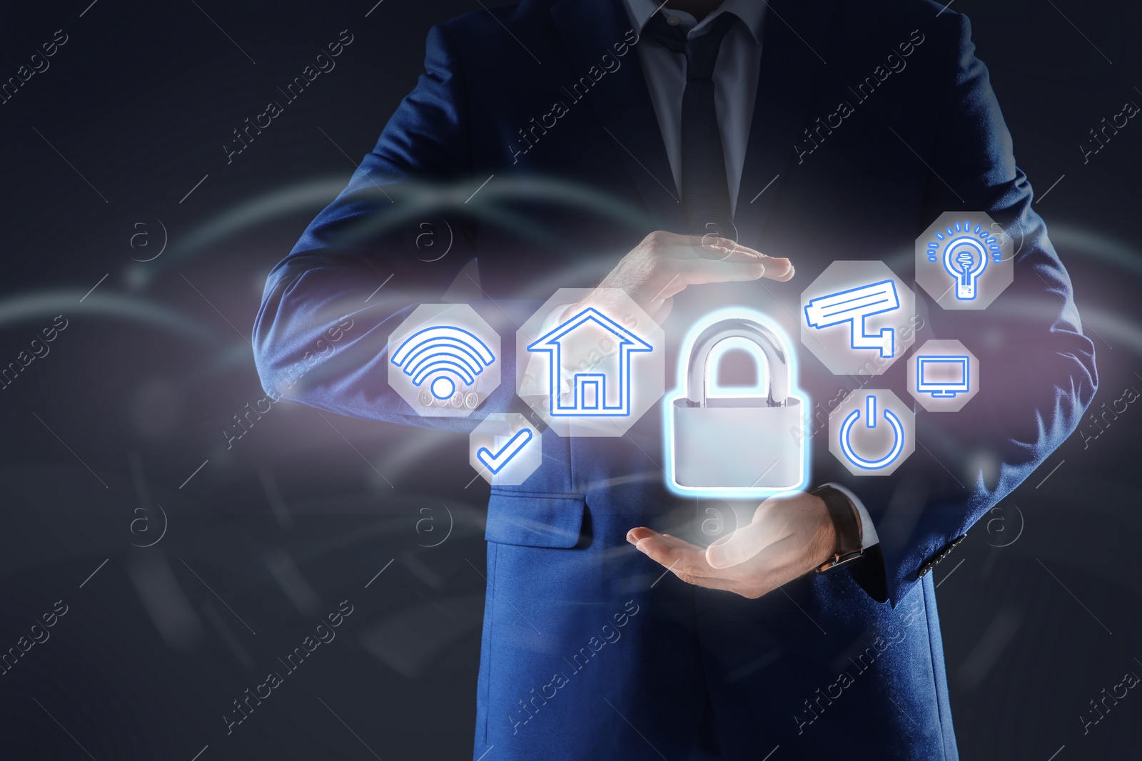 Image of Home security concept. Man holding lock on dark background, closeup