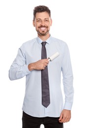 Handsome man cleaning shirt with adhesive lint roller on white background