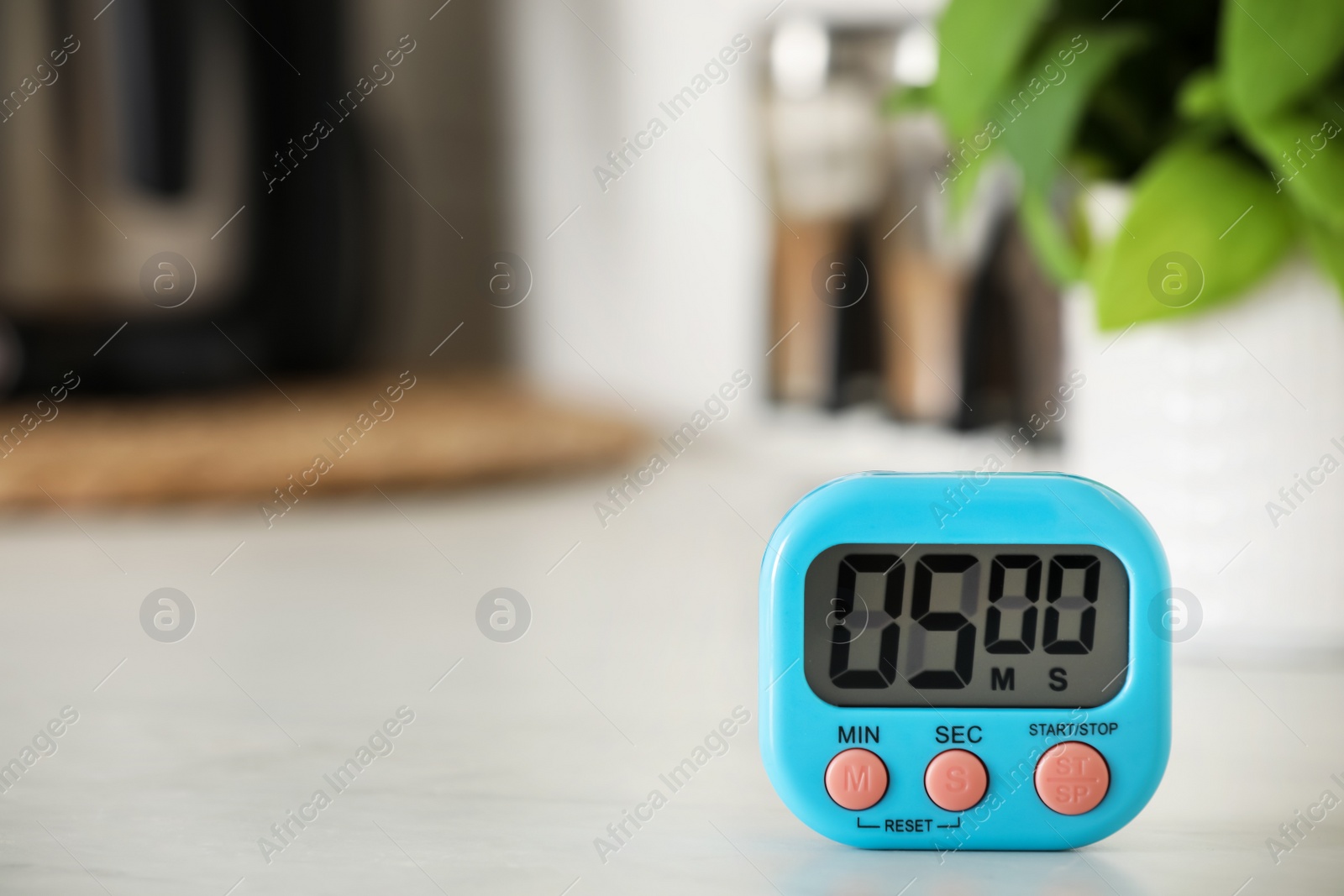 Photo of Digital kitchen timer on white table indoors. Space for text