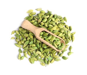 Photo of Wooden scoop with dry cardamom seeds on white background, top view