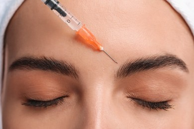 Photo of Young woman getting facial injection, closeup. Cosmetic surgery