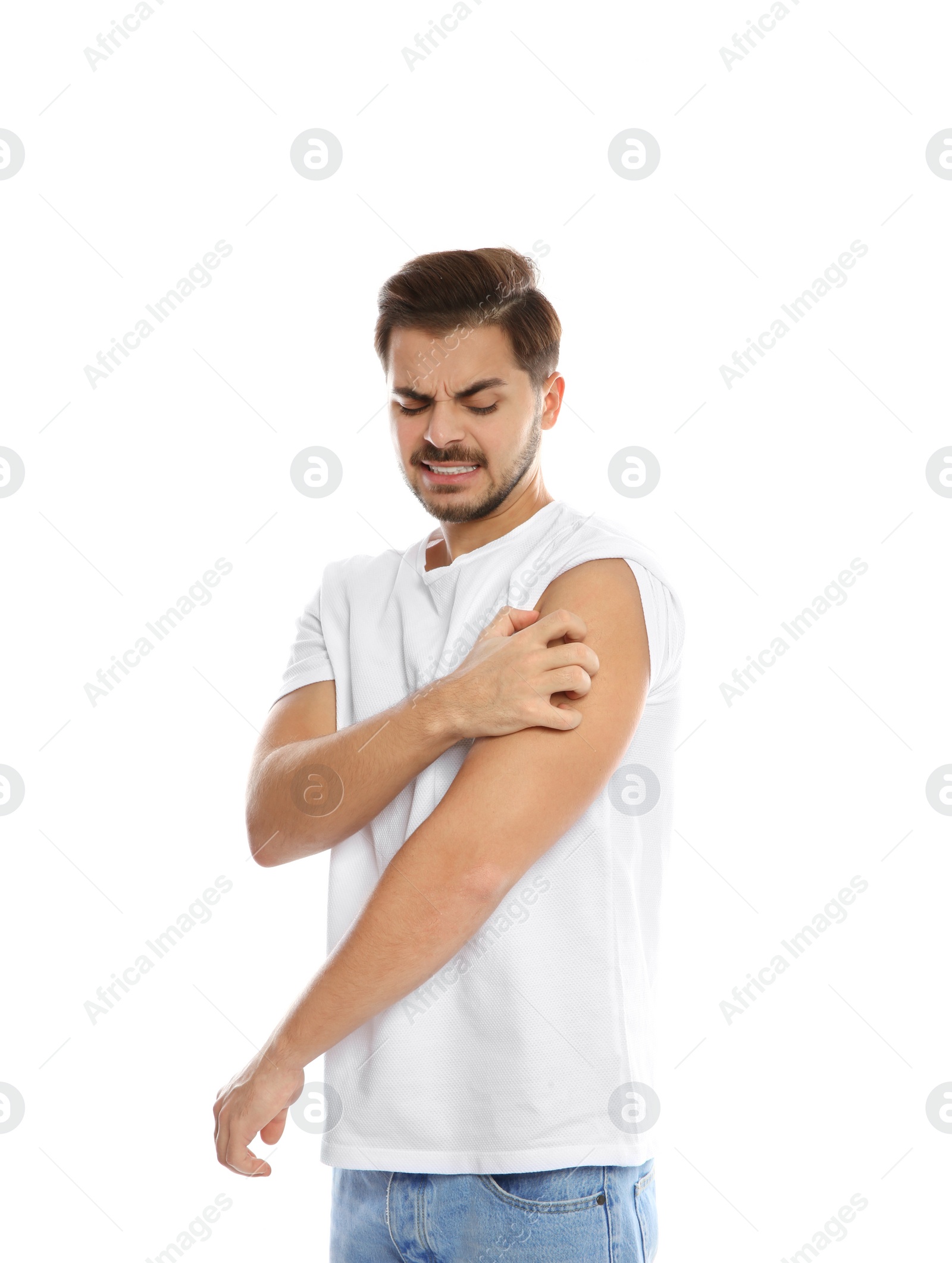 Photo of Young man scratching shoulder on white background. Annoying itch