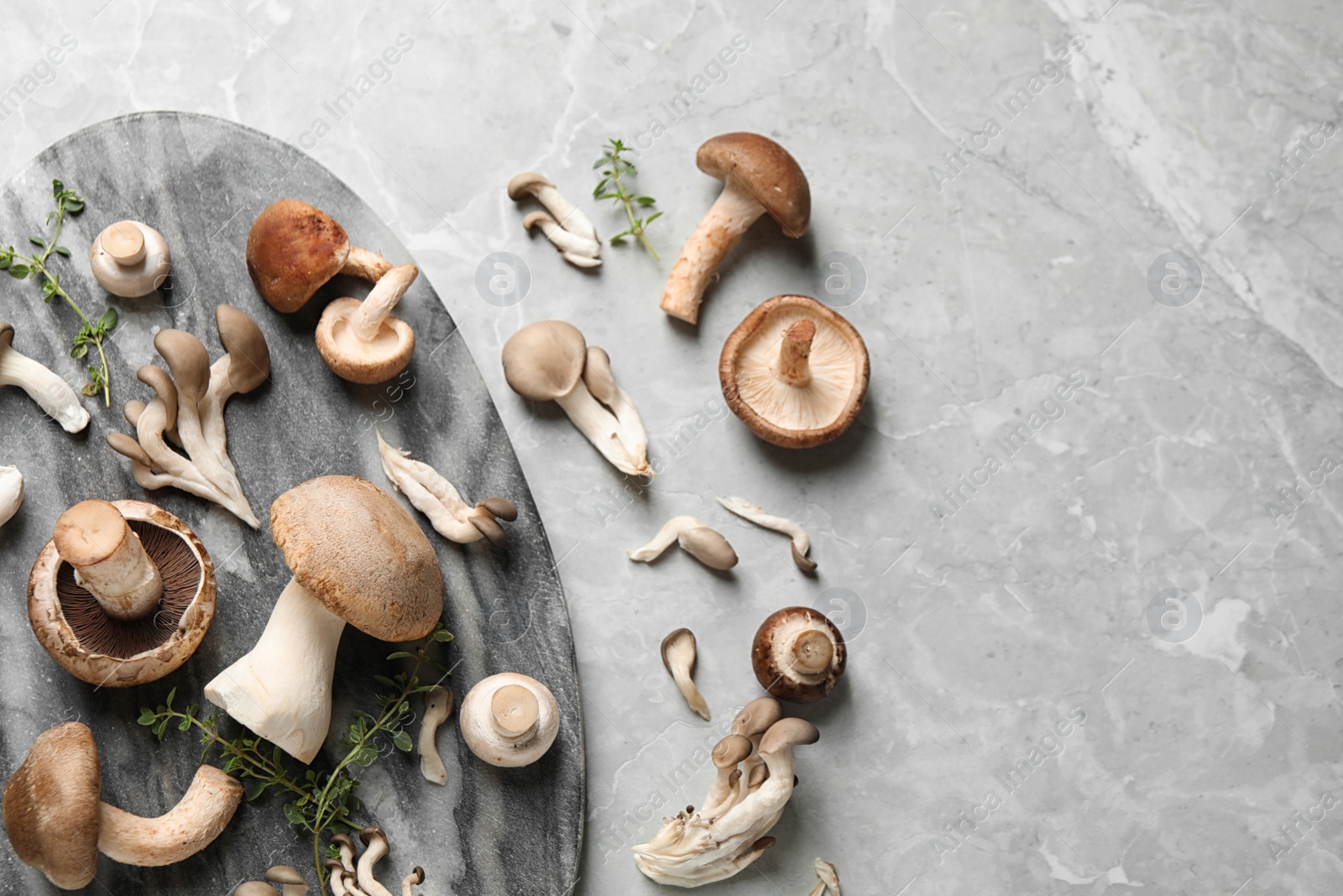 Photo of Flat lay composition with fresh wild mushrooms on light grey table