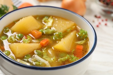 Photo of Bowl of delicious turnip soup on table, closeup view