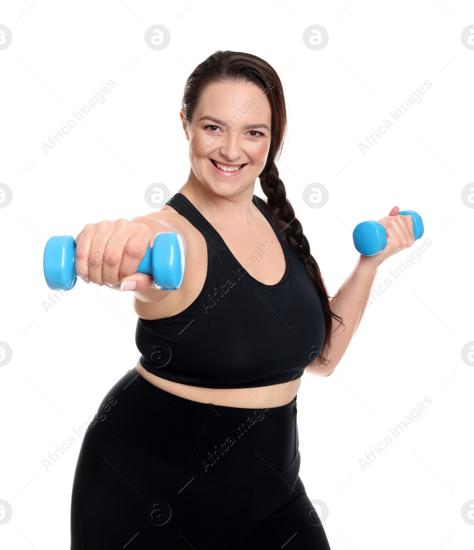 Photo of Happy overweight woman doing exercise with dumbbells on white background