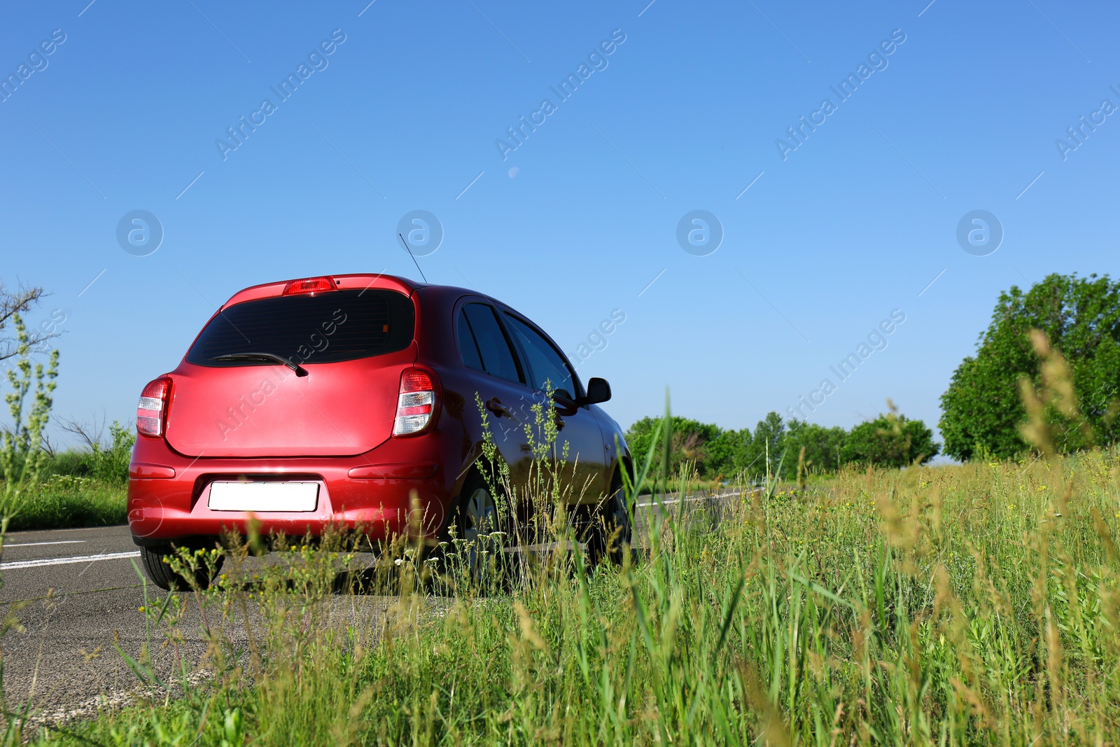 Photo of Modern color family car on highway. Space for text