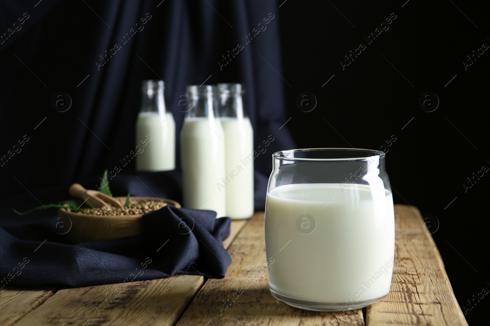 Photo of Jar of hemp milk on wooden table