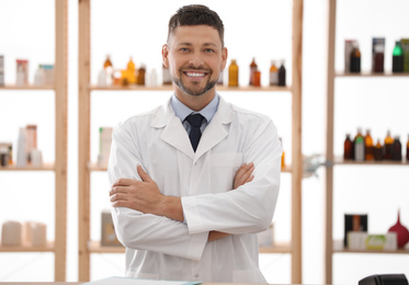 Portrait of happy male pharmacist in drugstore