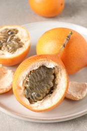 Delicious ripe granadillas on light table, closeup