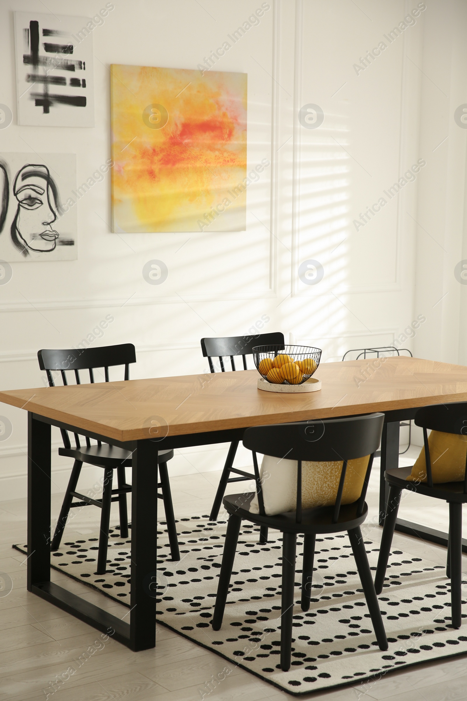 Photo of Stylish wooden dining table and chairs in room. Interior design