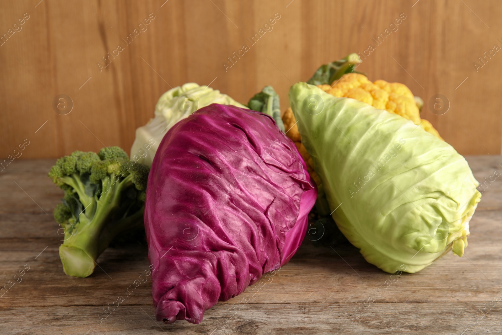 Photo of Different fresh cabbages on table. Healthy food