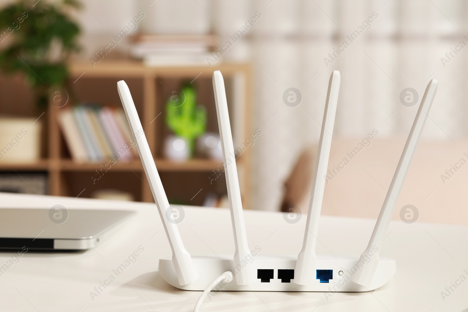 Photo of New Wi-Fi router on white table indoors