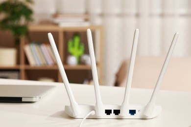 New Wi-Fi router on white table indoors