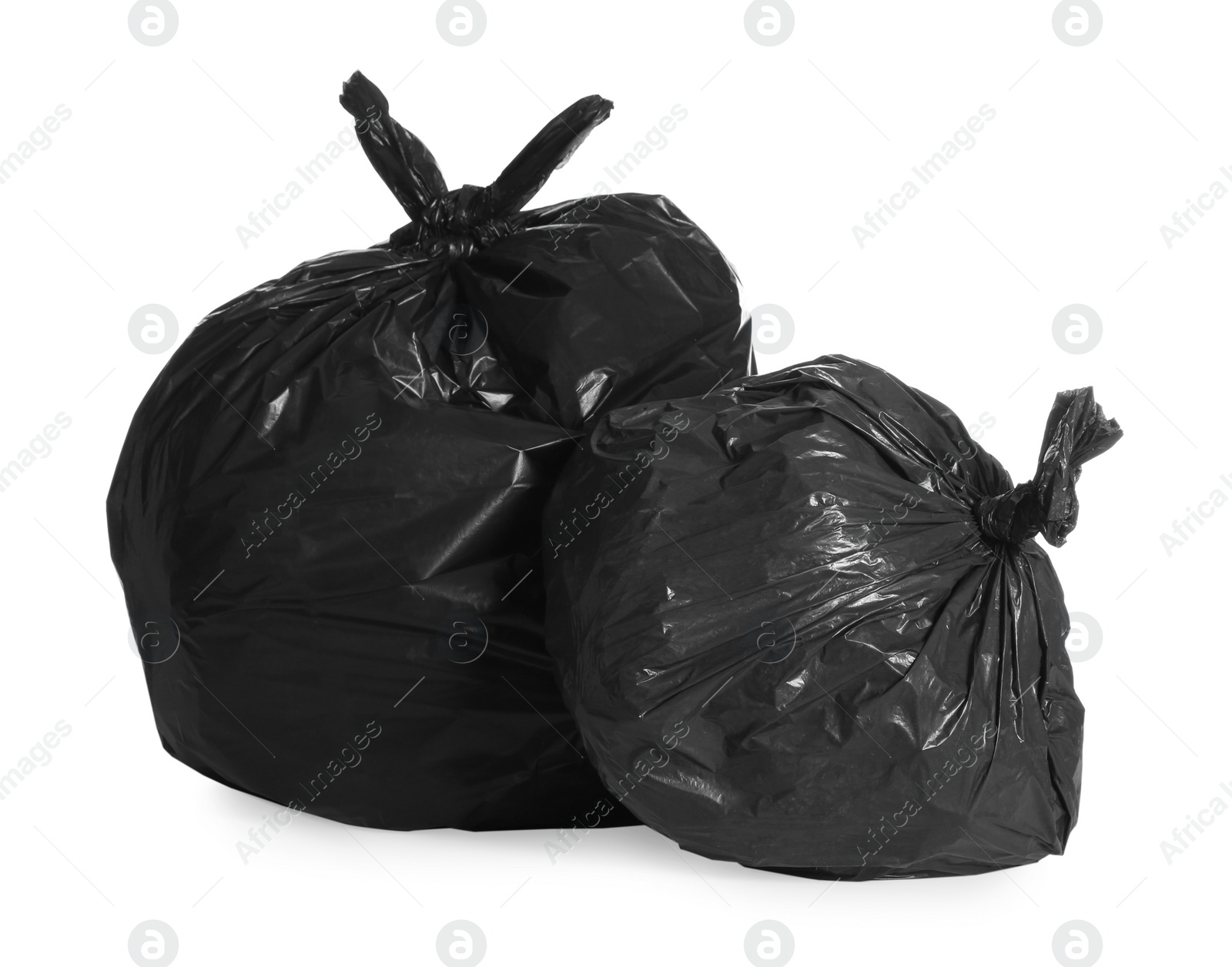 Photo of Black trash bags full of garbage on white background