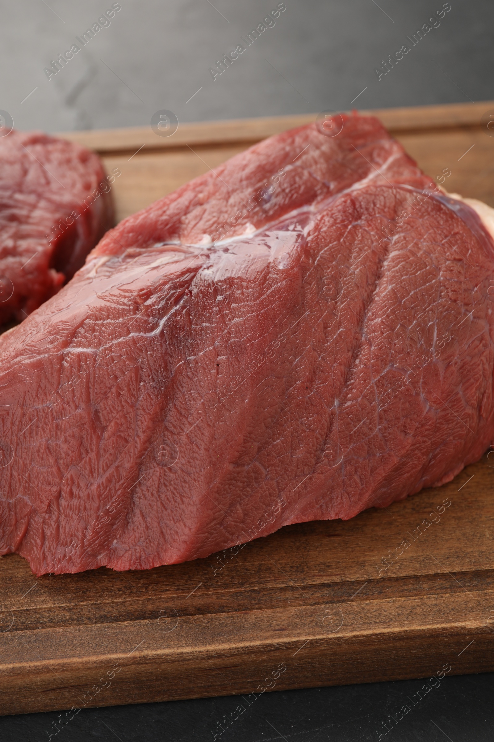 Photo of Piece of raw beef meat on table, closeup