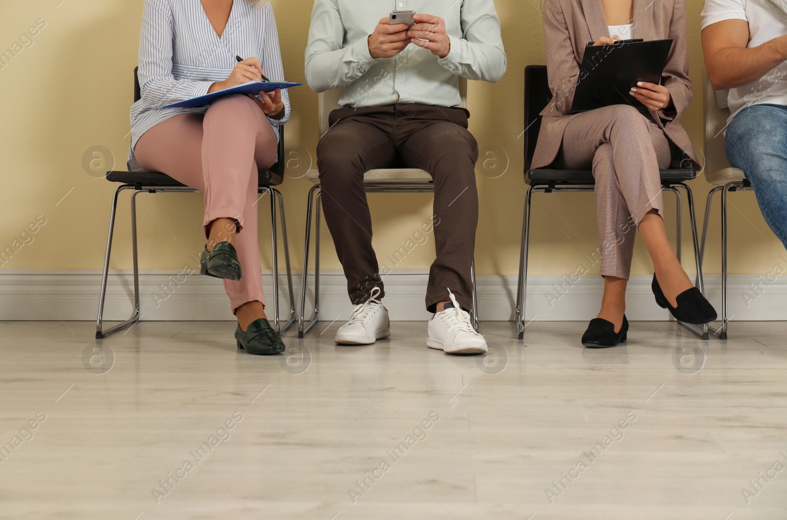 Photo of People waiting for job interview in office, closeup