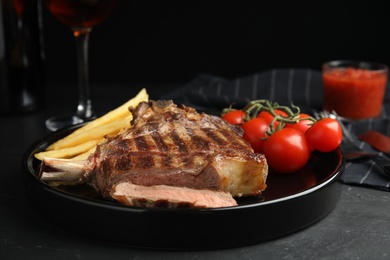 Image of Tasty grilled steak served on black table 