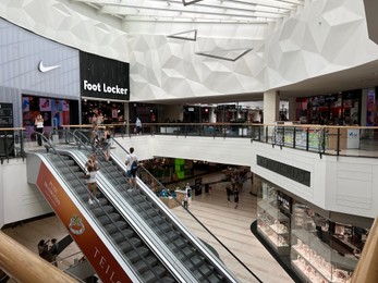 Photo of WARSAW, POLAND - JULY 13, 2022: Big shopping mall with many stores and escalator