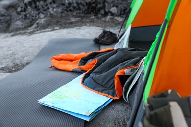 Photo of Sleeping bag and other camping gear outdoors