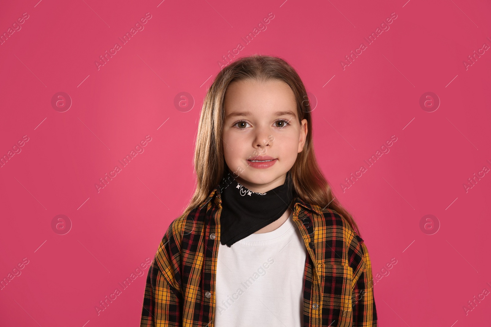 Photo of Cute little girl wearing stylish bandana on pink background