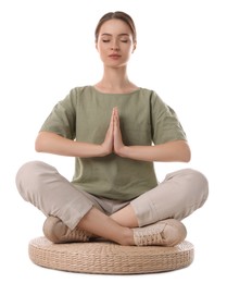 Beautiful young woman meditating on white background