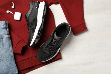 Flat lay composition with stylish sport shoes on light background