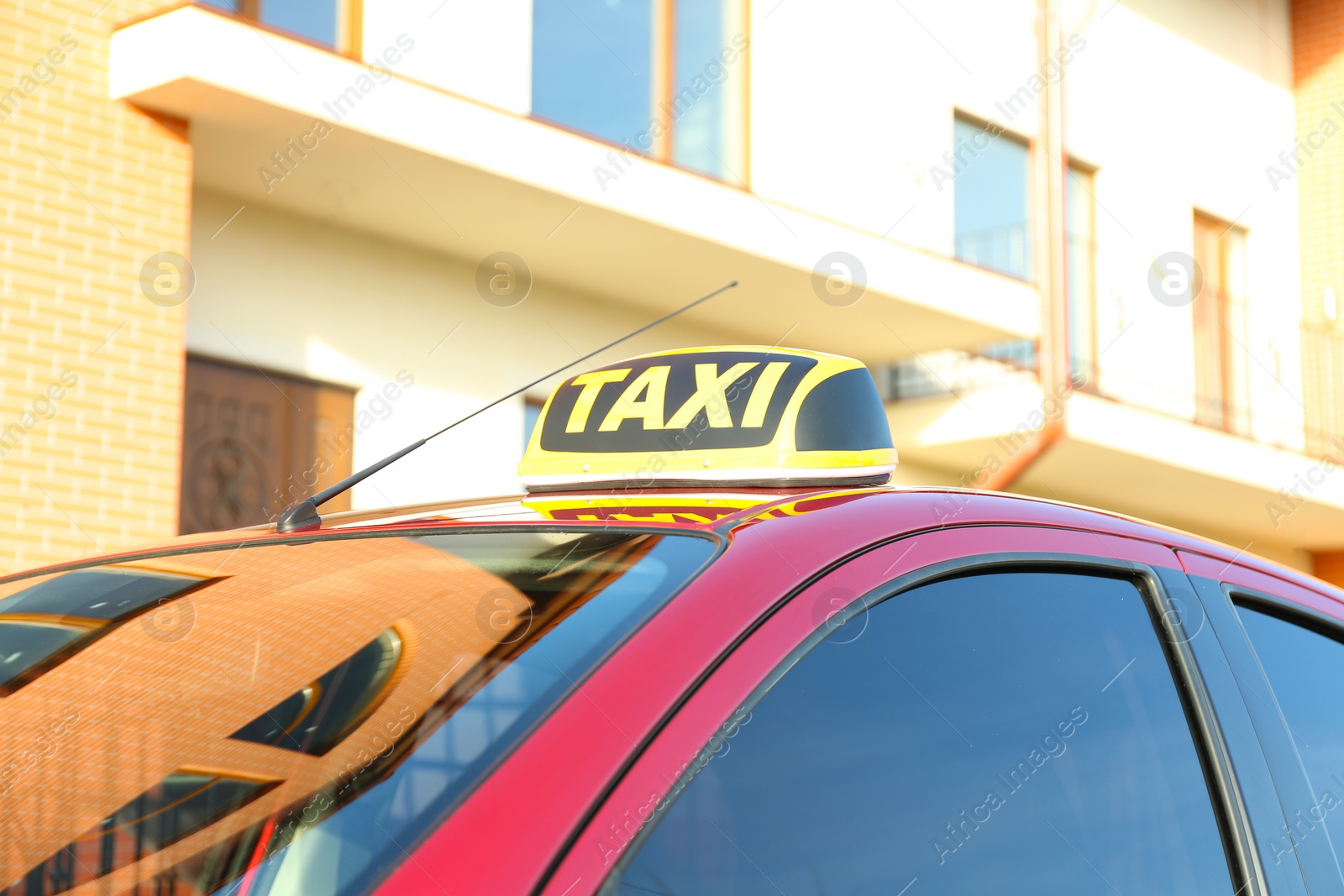 Photo of Roof light with word TAXI on car outdoors