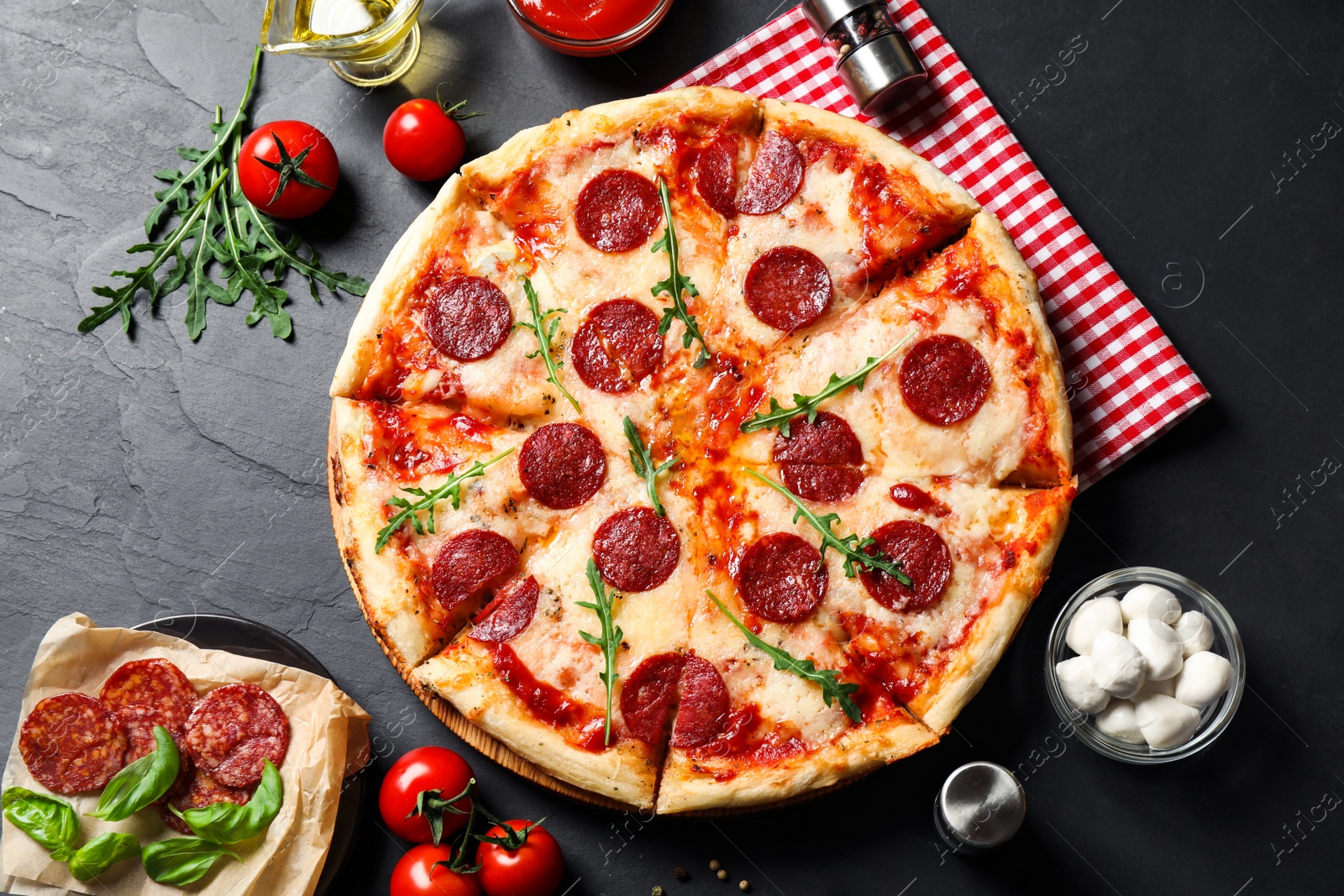 Photo of Flat lay composition with hot pepperoni pizza on dark table