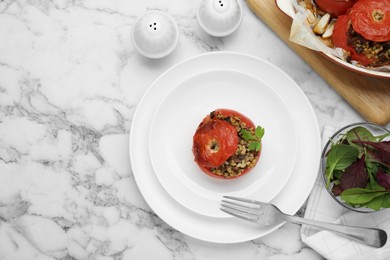 Photo of Delicious stuffed tomatoes with minced beef, bulgur and mushrooms on white marble table, flat lay. Space for text