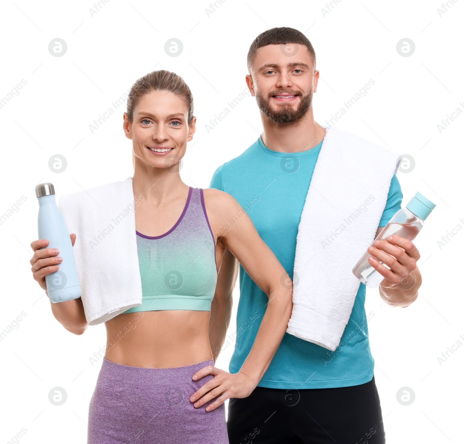 Photo of Athletic people with bottles of water and towels on white background