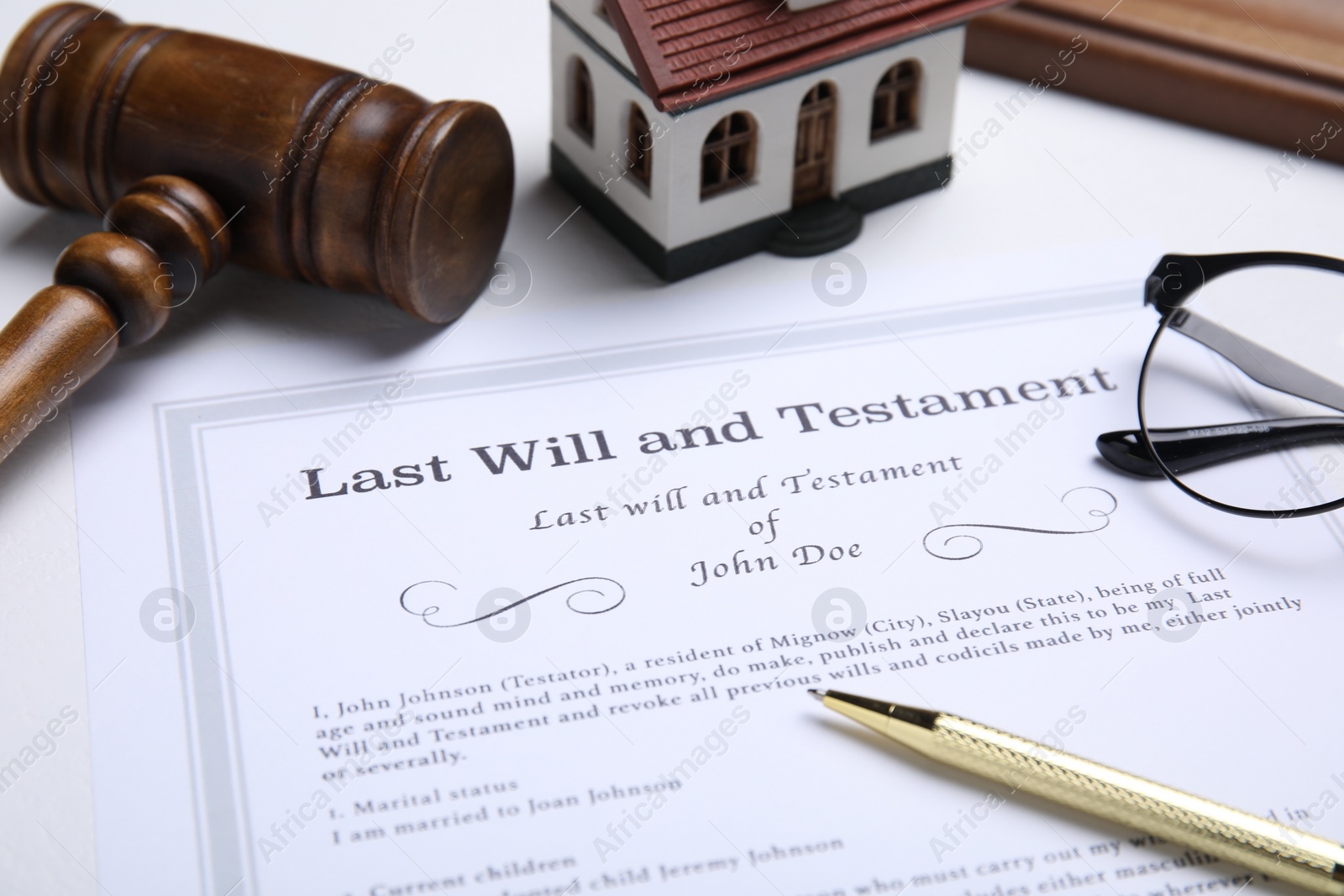 Photo of Last will and testament with pen on white table, closeup