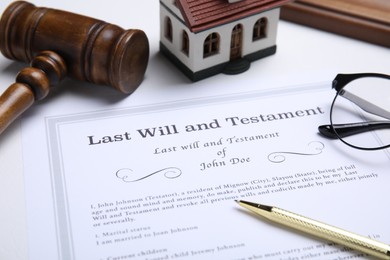 Last will and testament with pen on white table, closeup