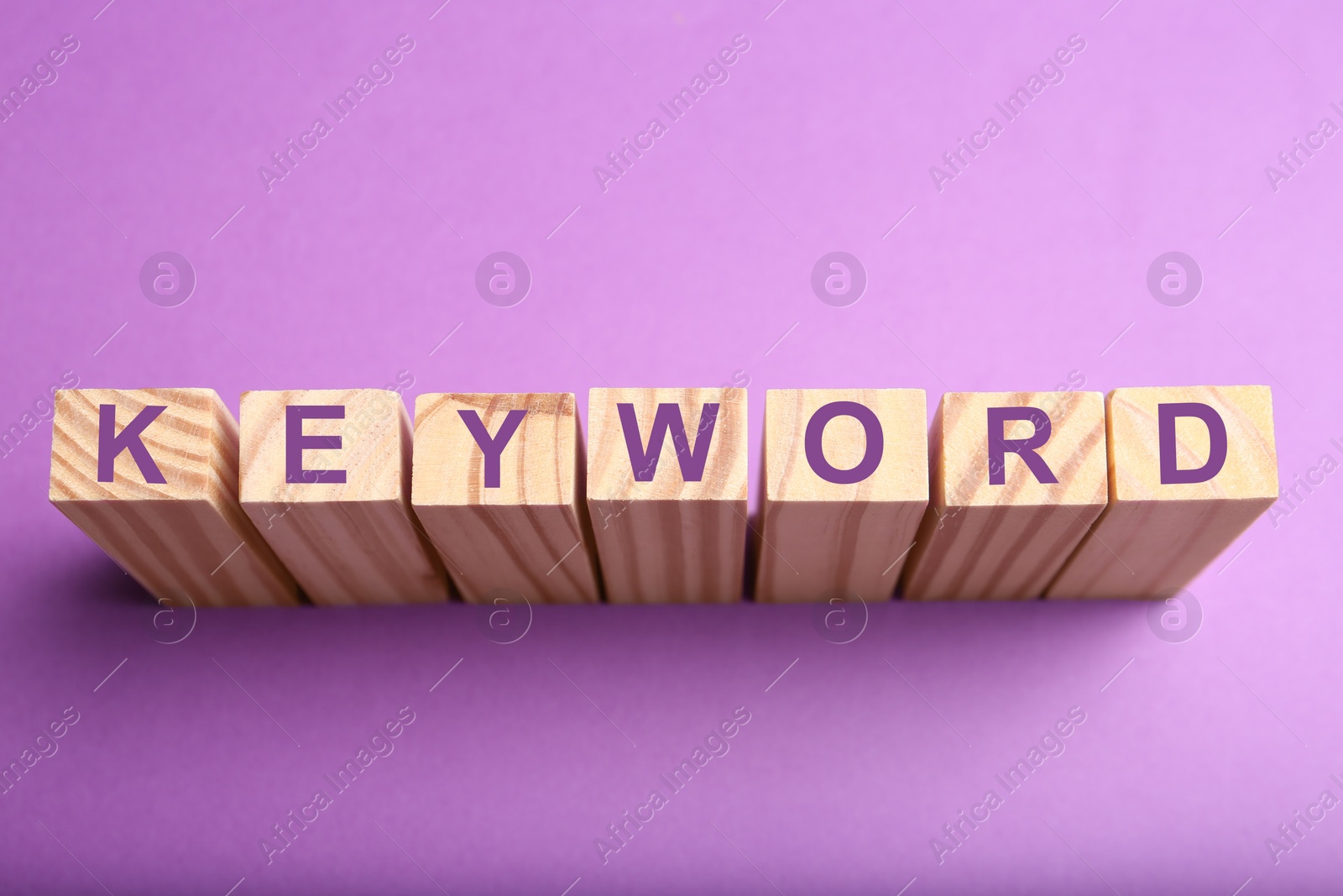 Photo of Blocks with word KEYWORD on lilac background, above view