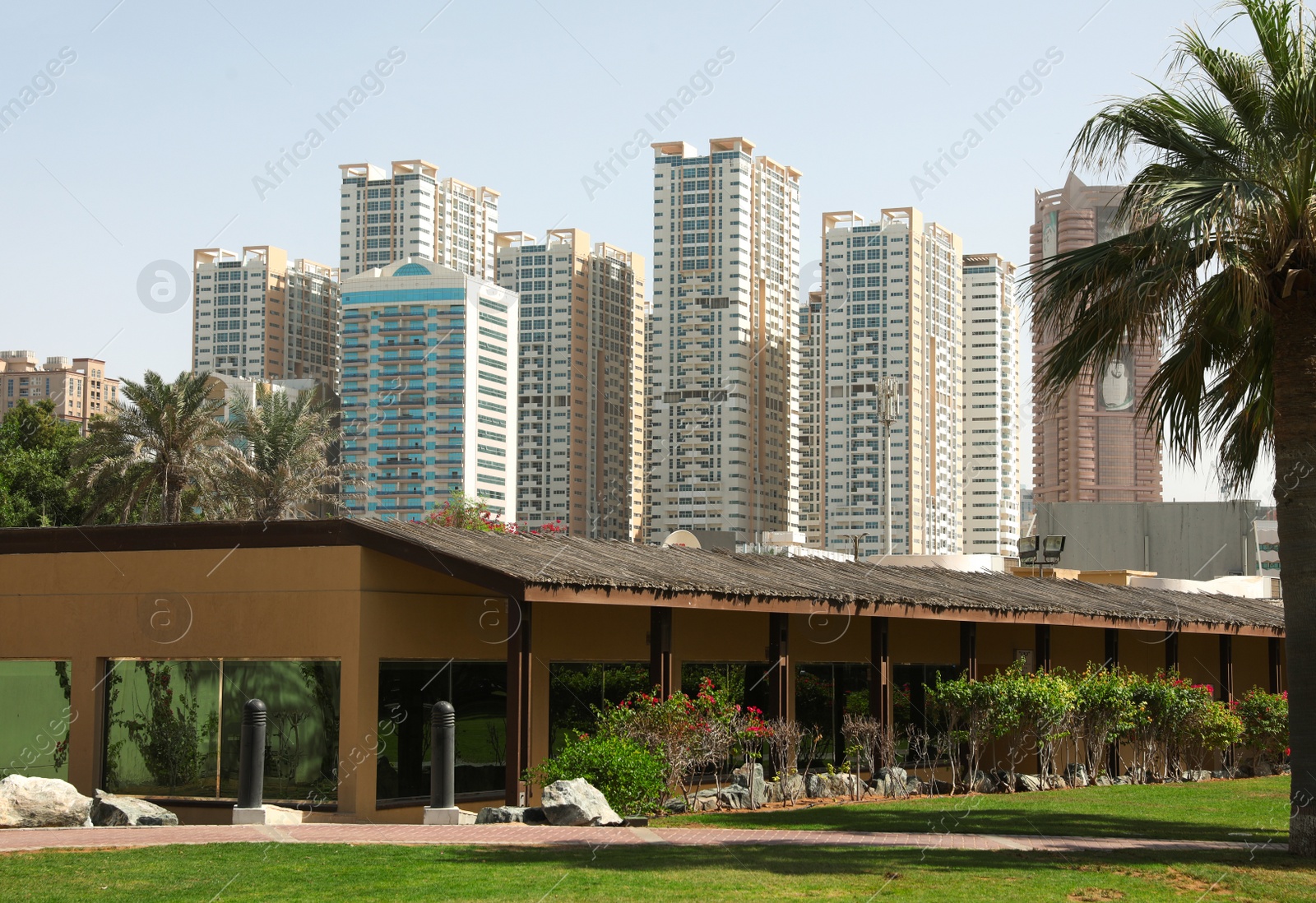 Photo of SHARJAH, UNITED ARAB EMIRATES - NOVEMBER 04, 2018: Beautiful landscape with tropical resort on sunny day