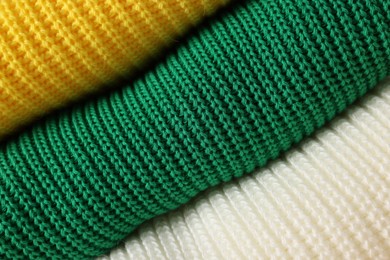 Closeup view of different warm folded sweaters as background