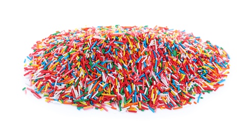 Photo of Pile of colorful sprinkles on white background. Confectionery decor